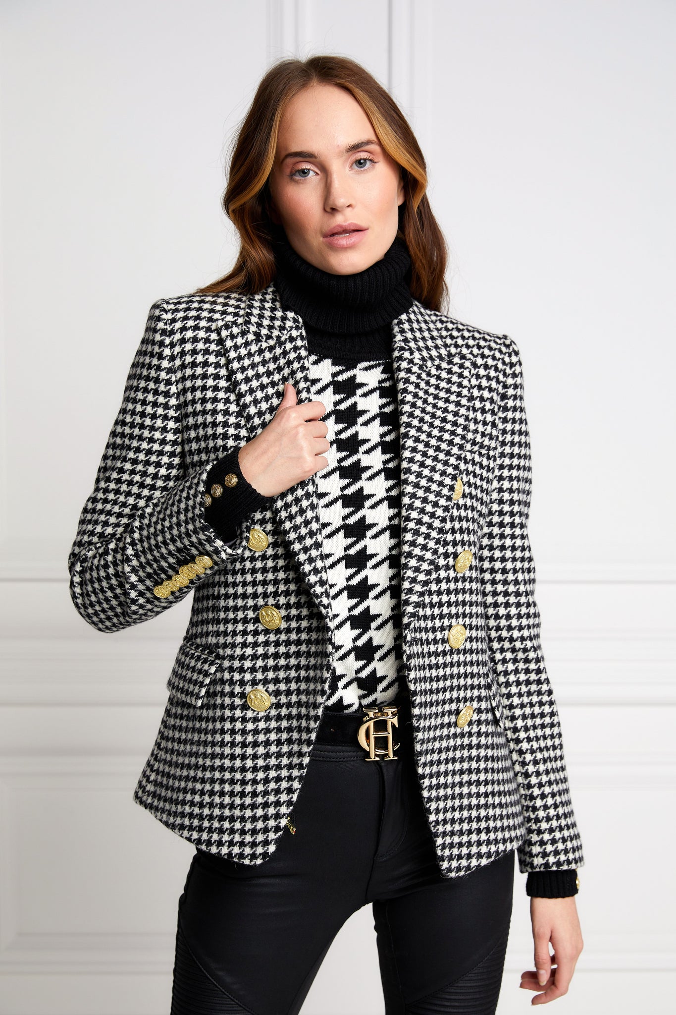 British made double breasted blazer that fastens with a single button hole to create a more form fitting silhouette with two pockets and gold button detailing this blazer in black and white houndstooth