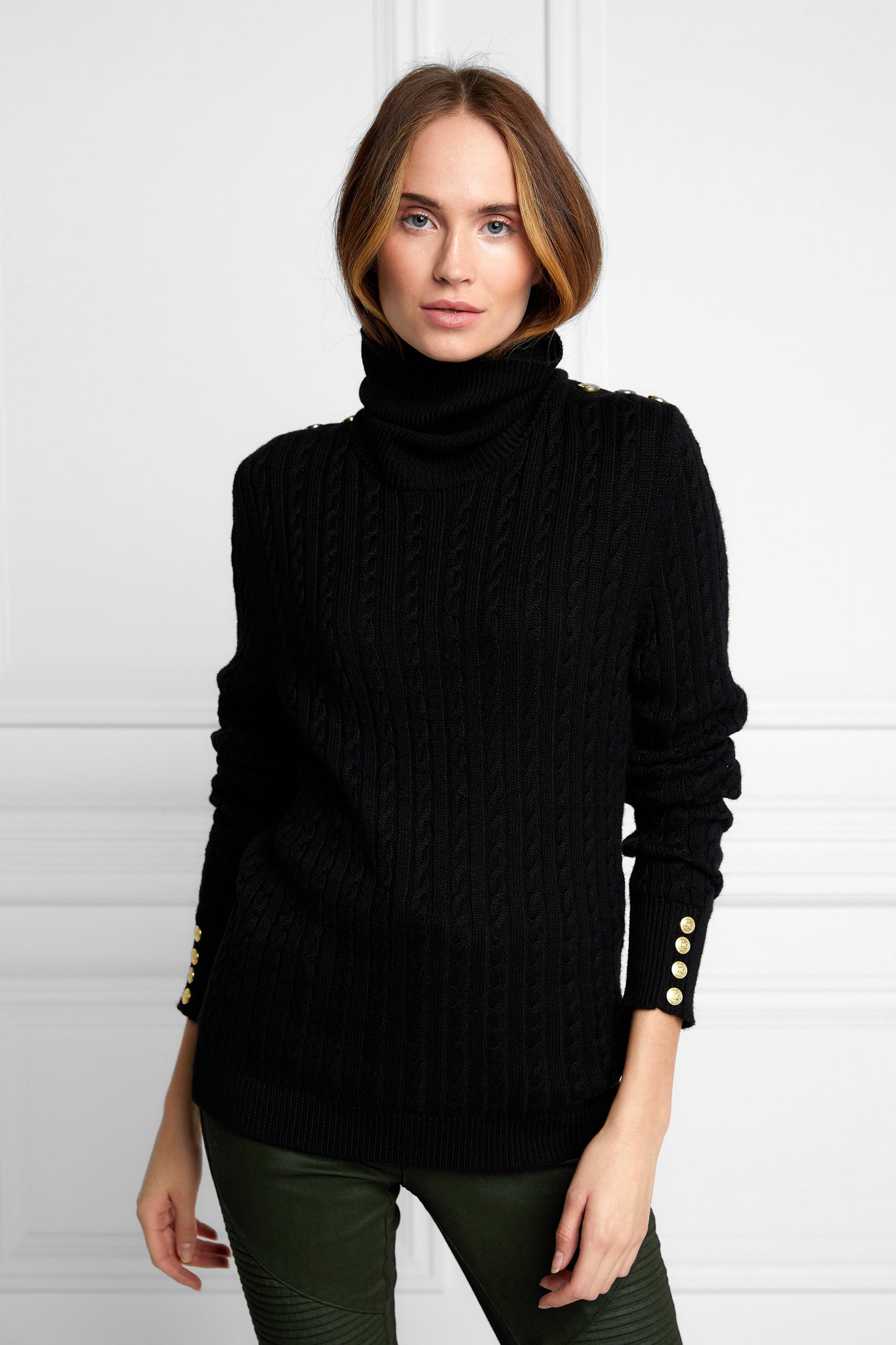 womens cable knit jumper in black with ribbed roll neck cuffs and hem