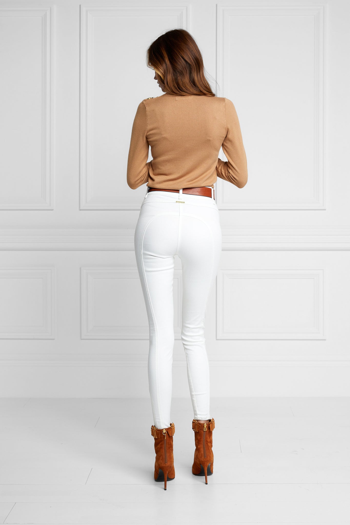 back of womens high rise white denim skinny stretch jean with jodhpur style seams and two open pockets to the front with hc embroidery on front left pocket