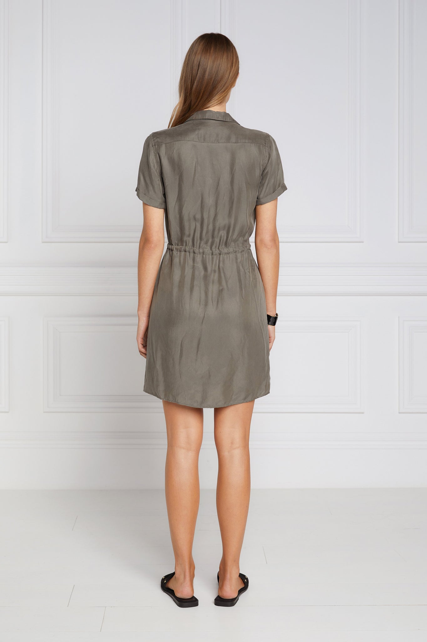 back shot of womens green military mini shirt dress with drawcord tie around the waist and gold buttons down the front