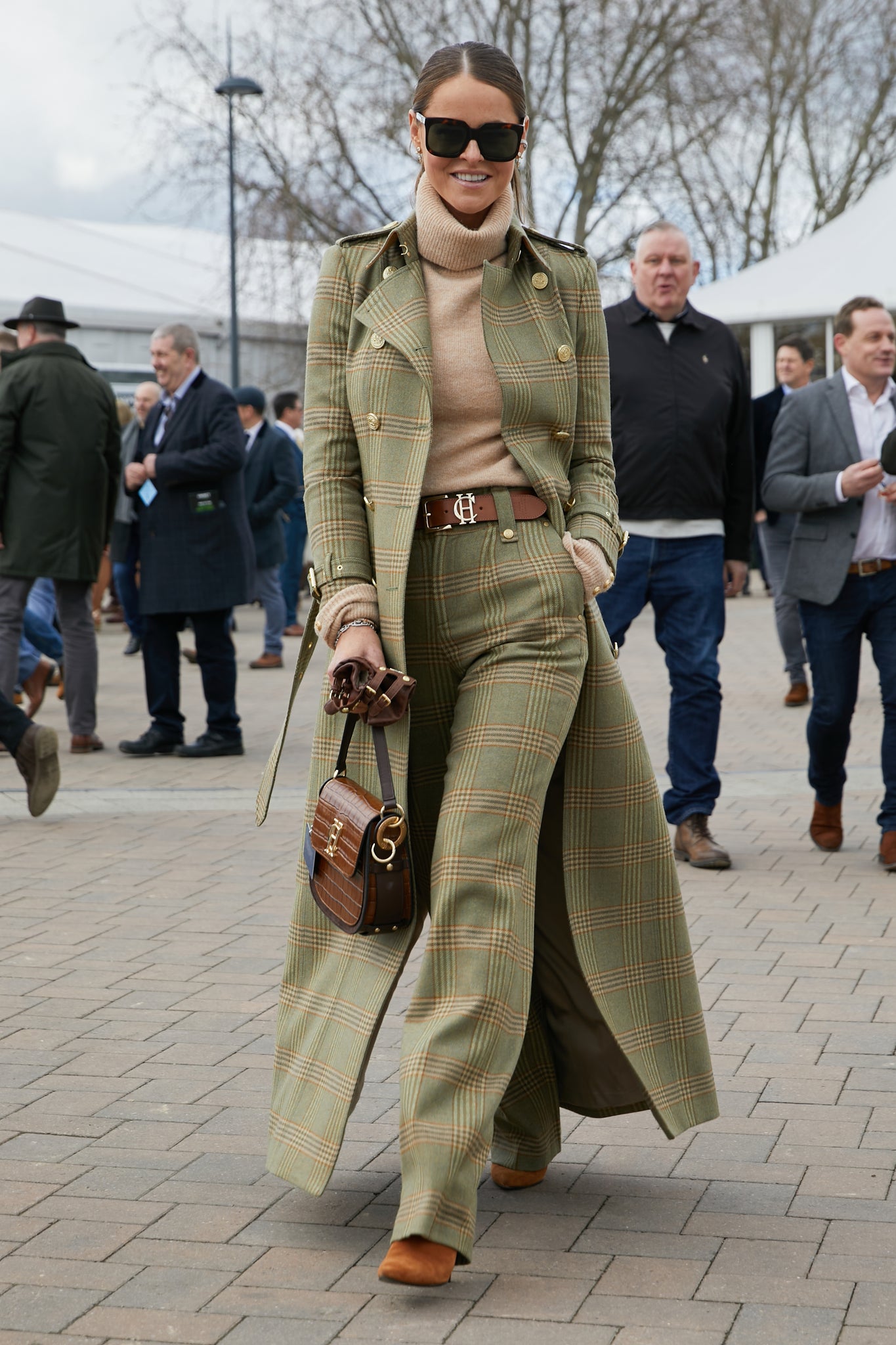 Women's leveret wool high waisted straight trousers with camel roll neck top, tan belt and leveret full length  trench coat, black sunglasses and tan croc handbag