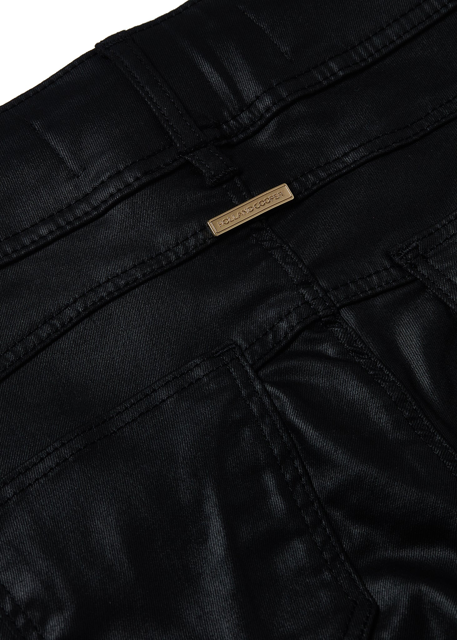 gold hardware on back of womens high rise black coated skinny jean for a leather look with pin tuck biker panels to front and two open zip pockets on front with two open pockets on back