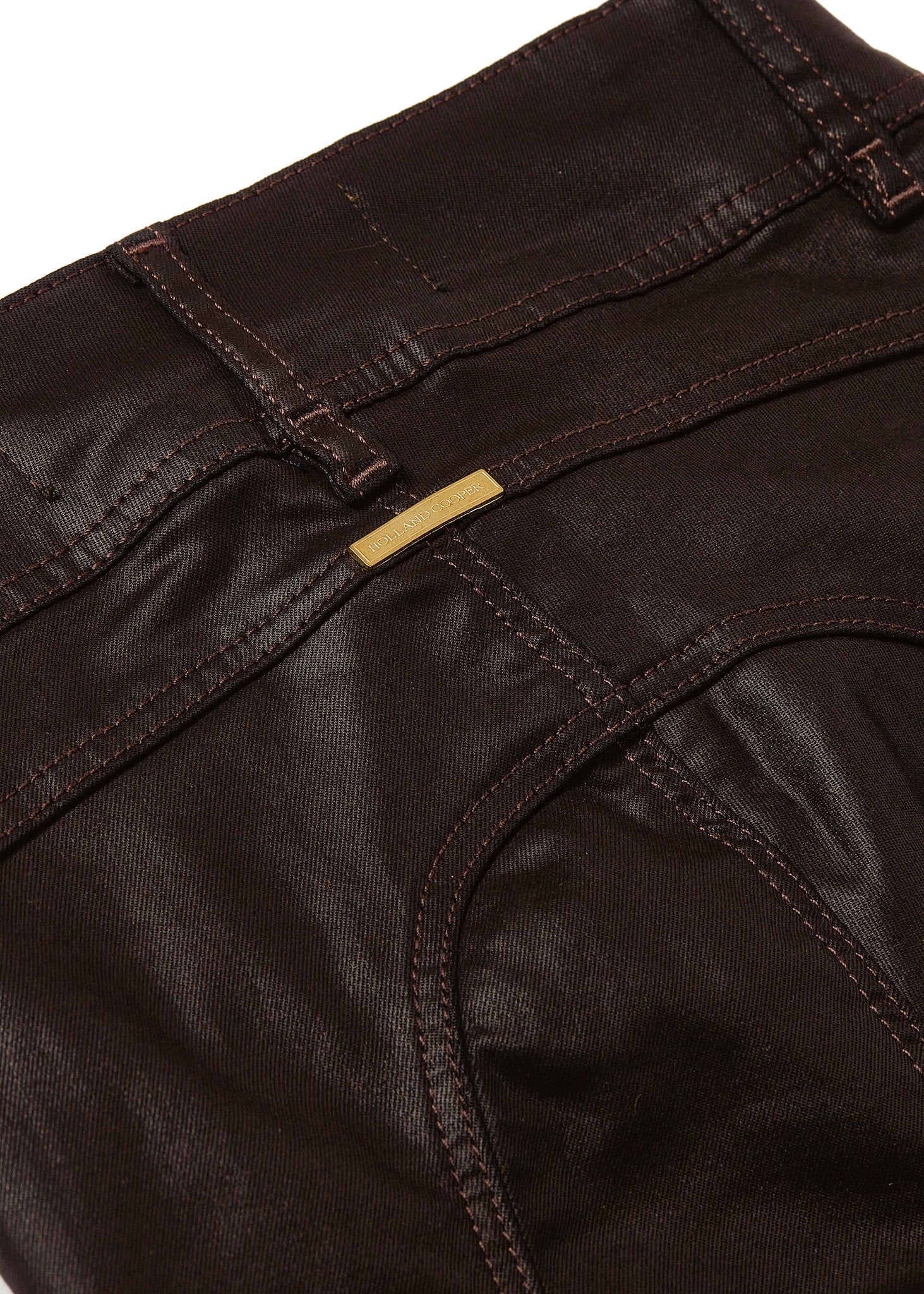 gold hardware detail on back of womens high rise brown coated skinny jean for a waxed look with jodhpur style seams and two open zip pockets to the front with HC branded pulls