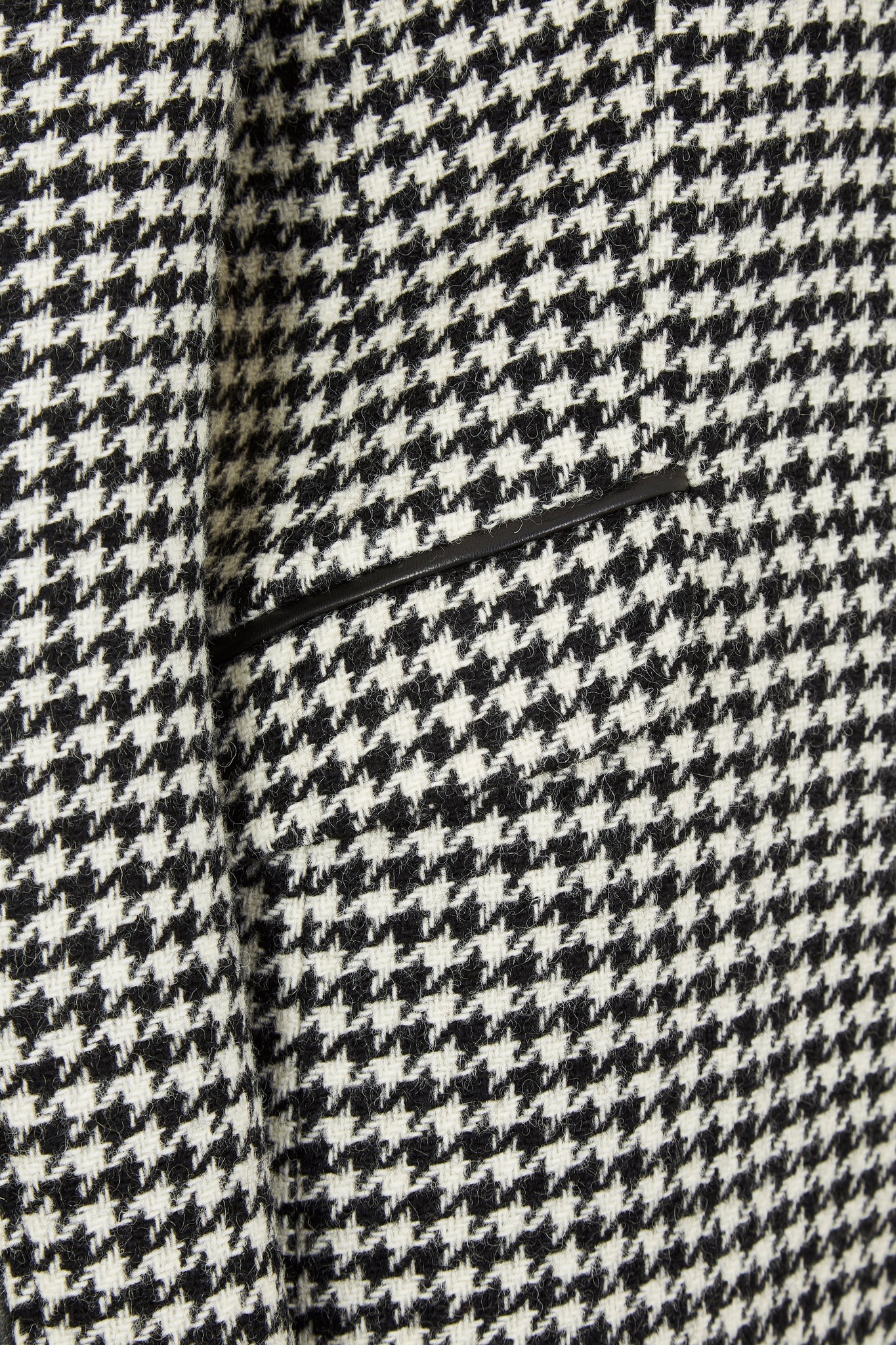 pocket detail of white and black houndstooth tweed womens coat with gold hardware and black leather detailing