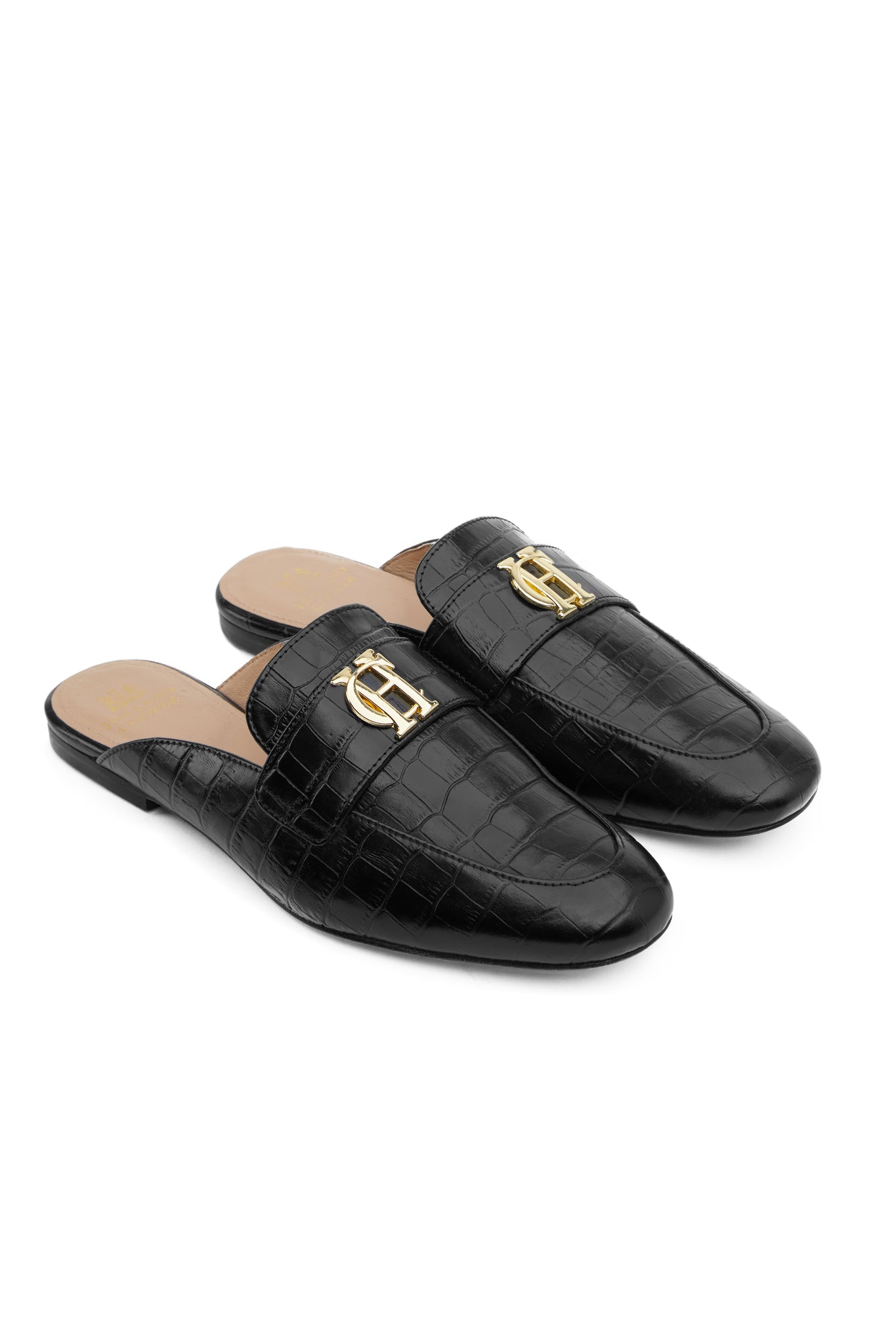 Black croc embossed leather backless loafers with a slightly pointed toe and gold hardware to the top