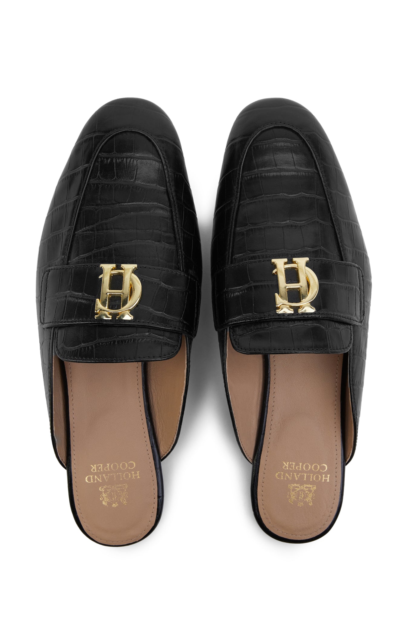 Birds eye view of black croc embossed leather backless loafers with a slightly pointed toe and gold hardware to the top with gold foil branding to the inner sole