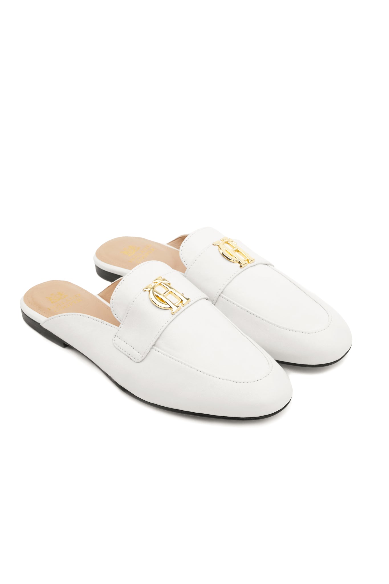white leather backless loafers with a slightly pointed toe and gold hardware to the top