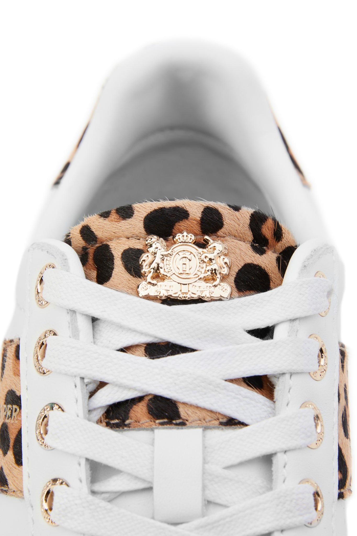 Close up of leopard print tongue of the trainer with gold crest