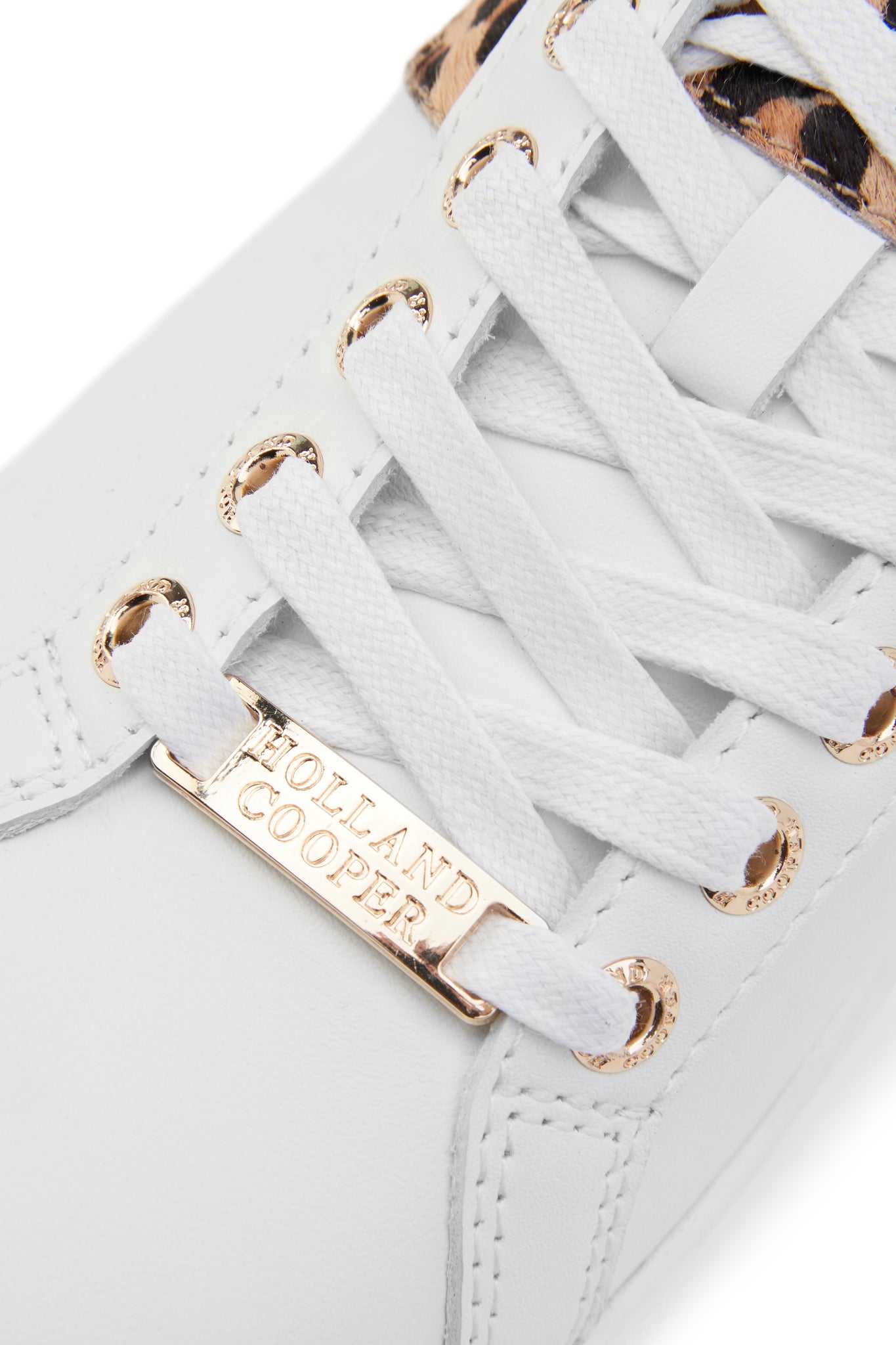 Close up of gold hardware and white laces