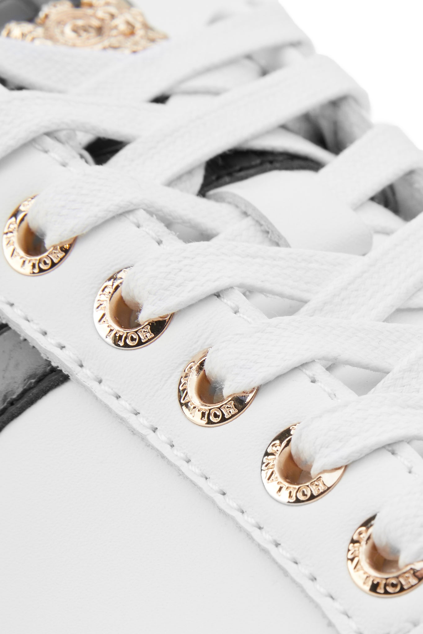 Close up of gold hardware on the laces for the trainer