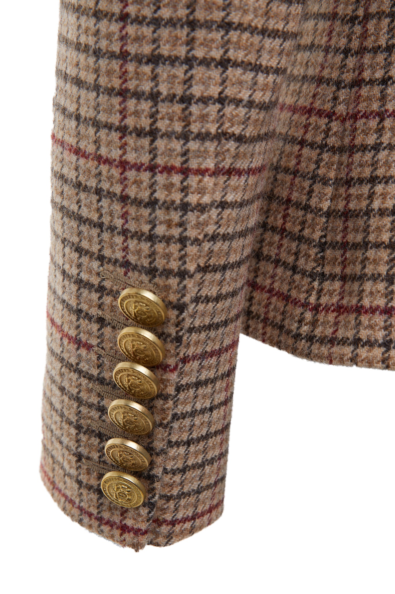 gold button detail on sleeves of British made double breasted blazer that fastens with a single button hole to create a more form fitting silhouette with two pockets and gold button detailing this blazer is made from camel black and red check charlton tweed