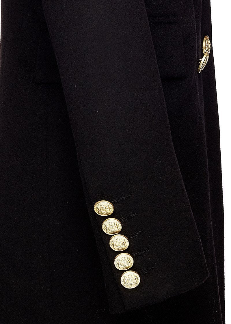 sleeve detail of black wool womens coat with gold hardware