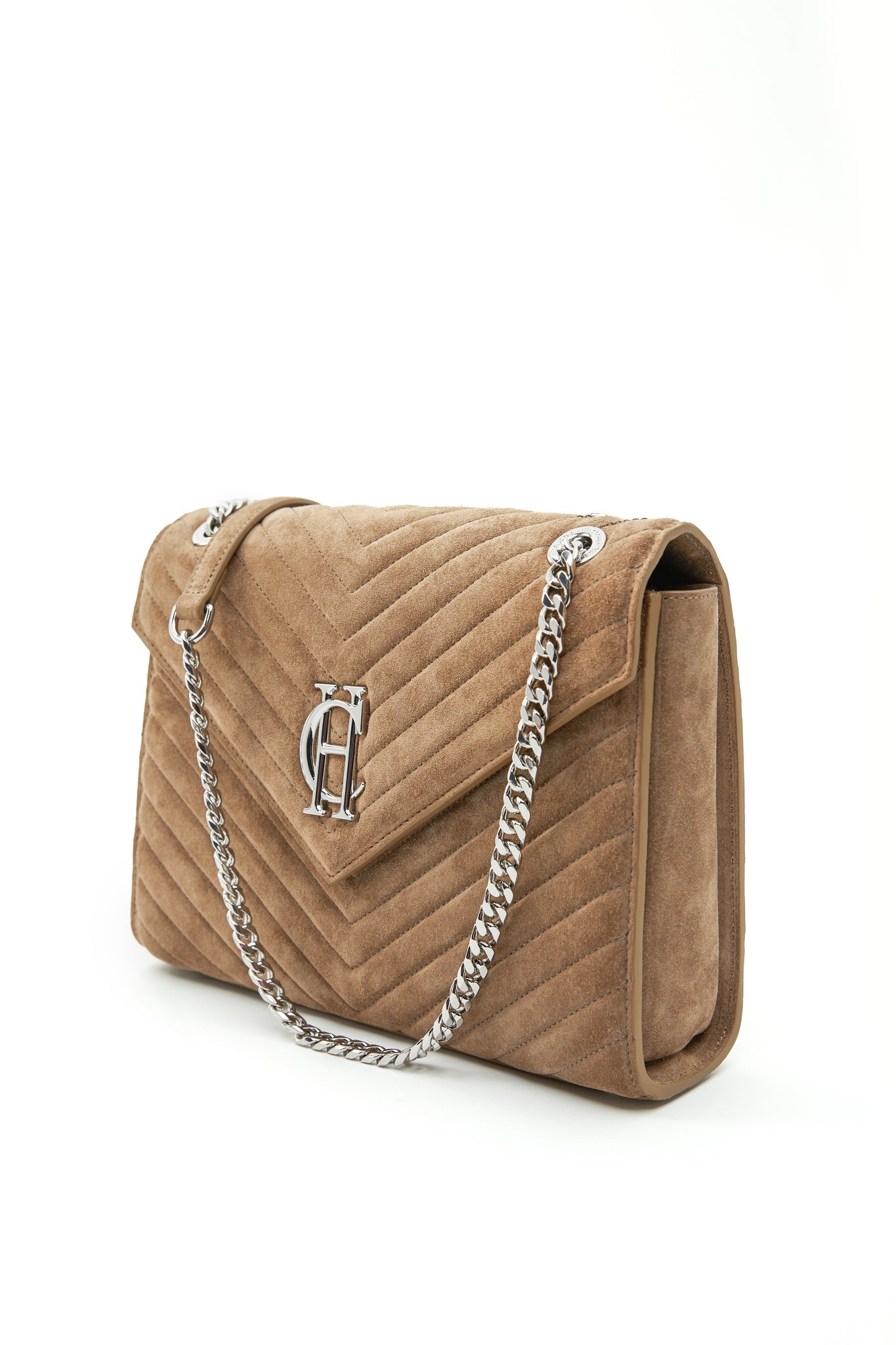side shot of taupe suede shoulder bag with silver hardware and chain