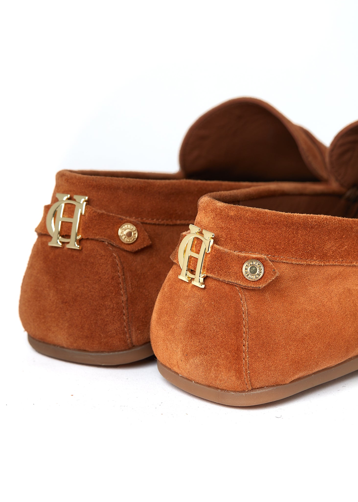 back of classic tan suede loafers with a leather sole and gold hardware