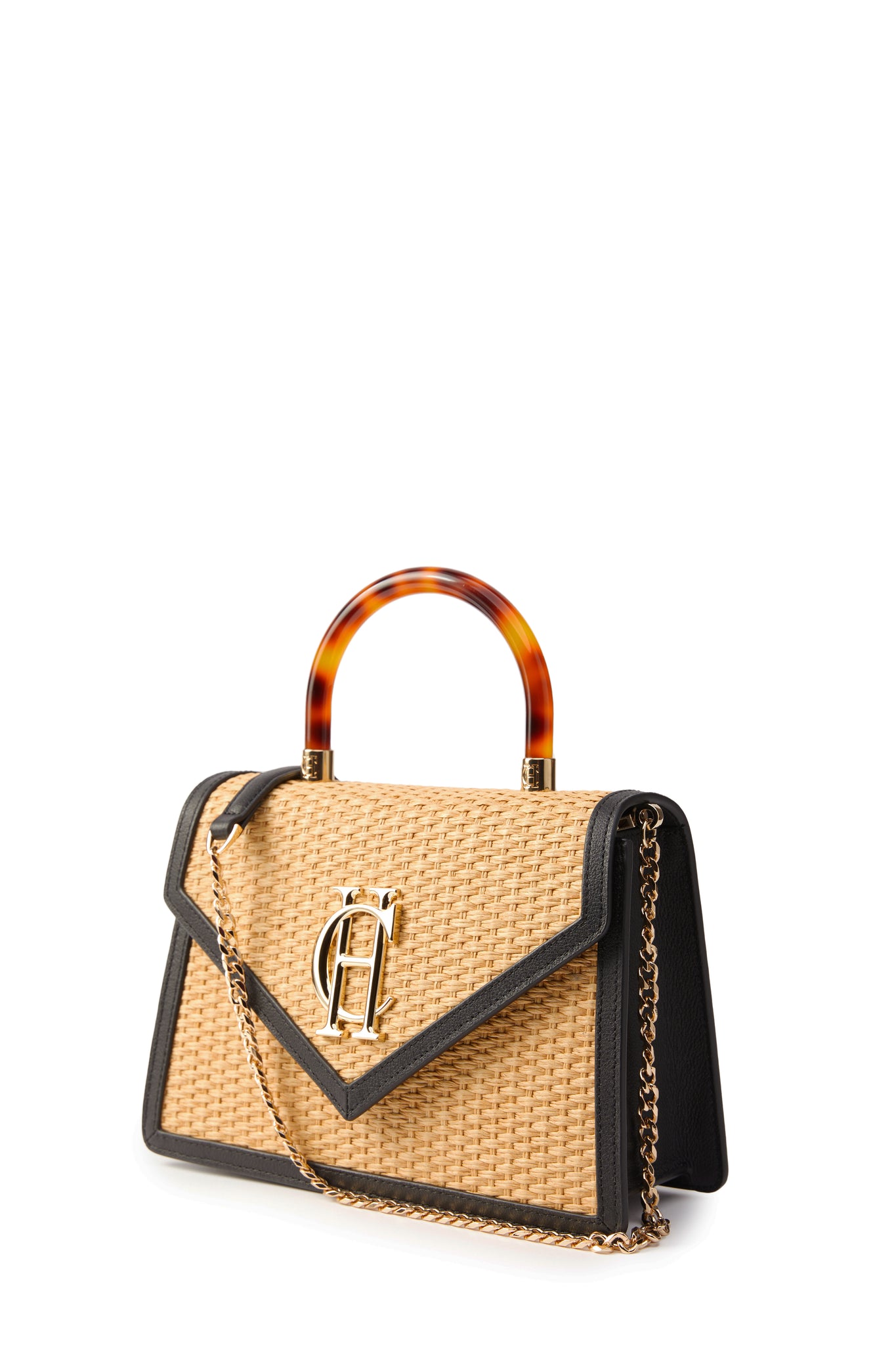 side image of natural raffia bag with acetate tortoiseshell effect top handle and gold chain