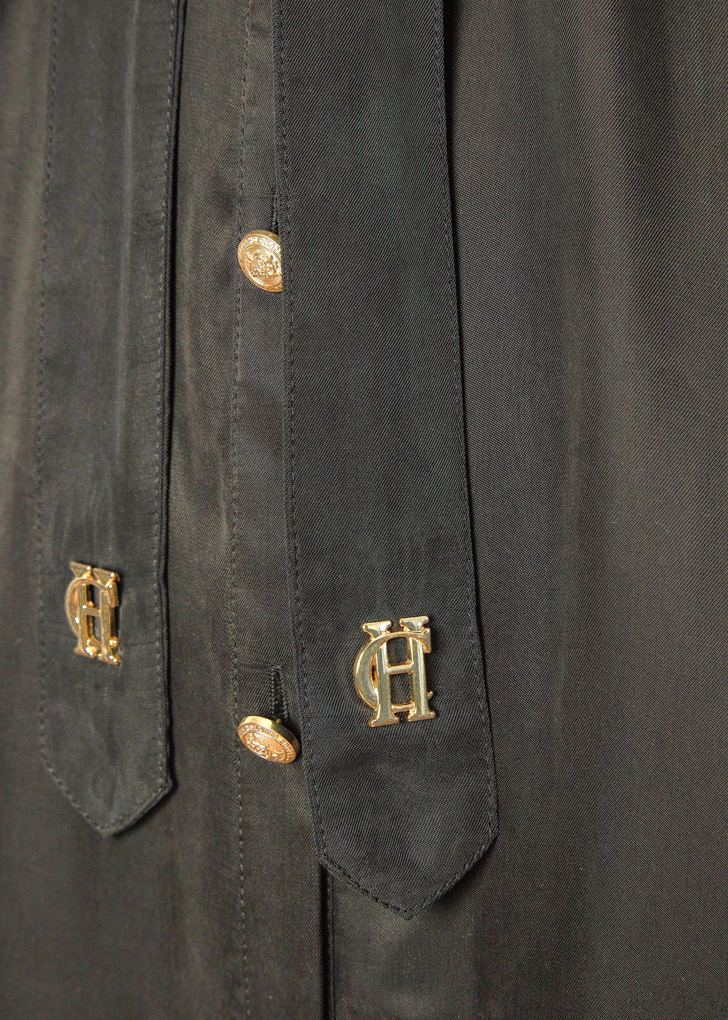 detail shot of gold buttons and HC hardware on womens green military midi shirt dress