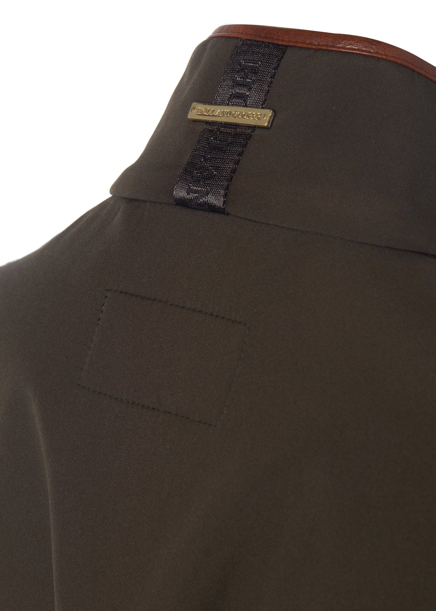 detail shot of the logo on the back of the collar on the womens khaki gilet with dark brown leather seams
