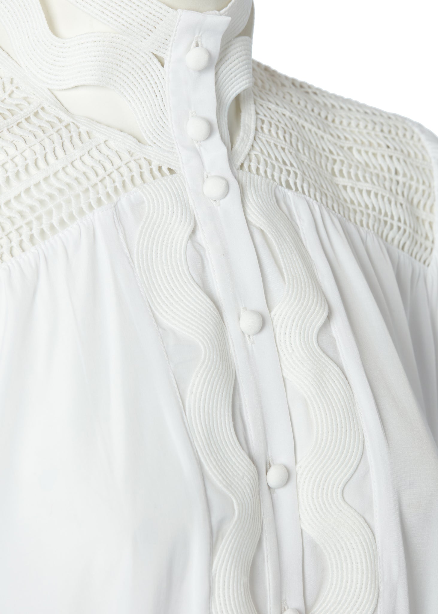 button detail on womens white polyester shirt with lace detail to the collar shoulders and arm cuffs and balloon sleeve