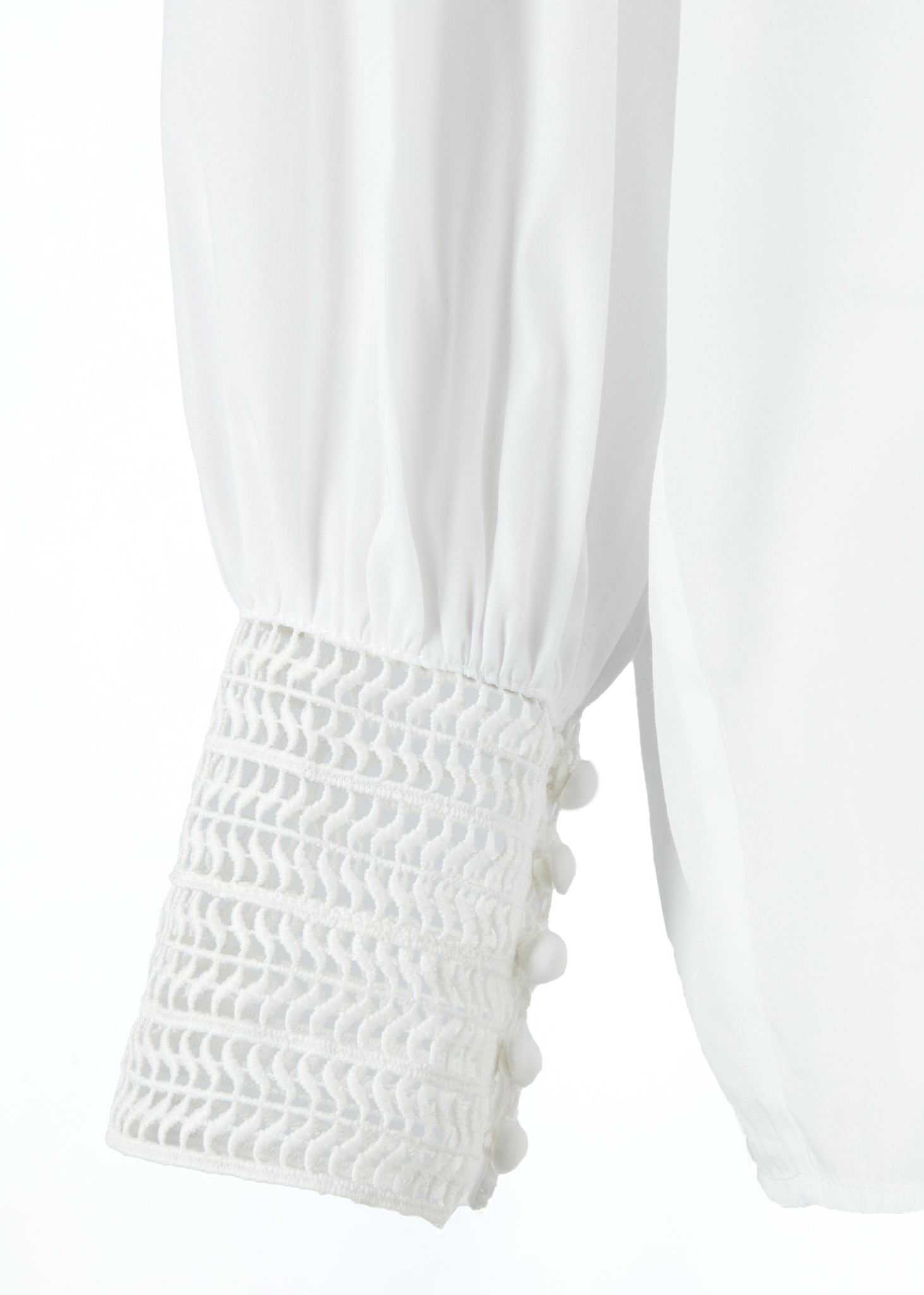 arm cuff detail on womens white polyester shirt with lace detail to the collar shoulders and arm cuffs and balloon sleeve