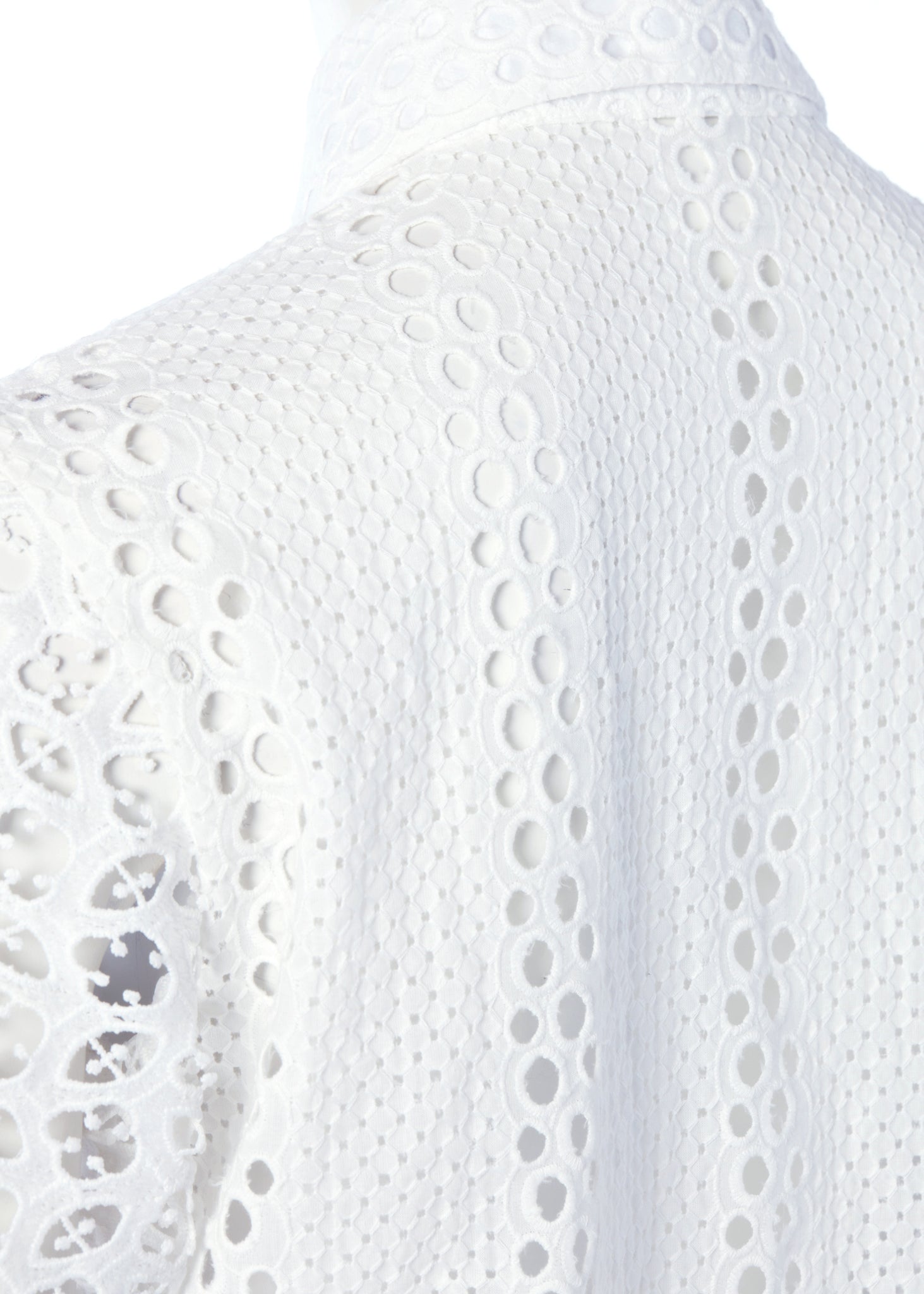 shoulder detail of womens long sleeve white cotton broderie anglaise shirt with voluminous sleeves and front buttons 