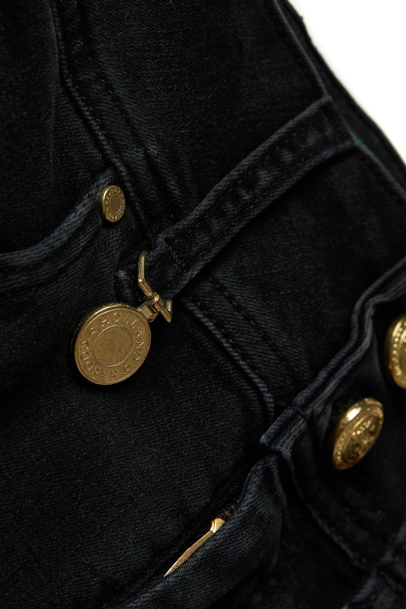 gold charm on belt loop detail on womens high rise washed black denim skinny stretch jean with jodhpur style seam and two open pockets to the front with hc embroidery on front left pocket