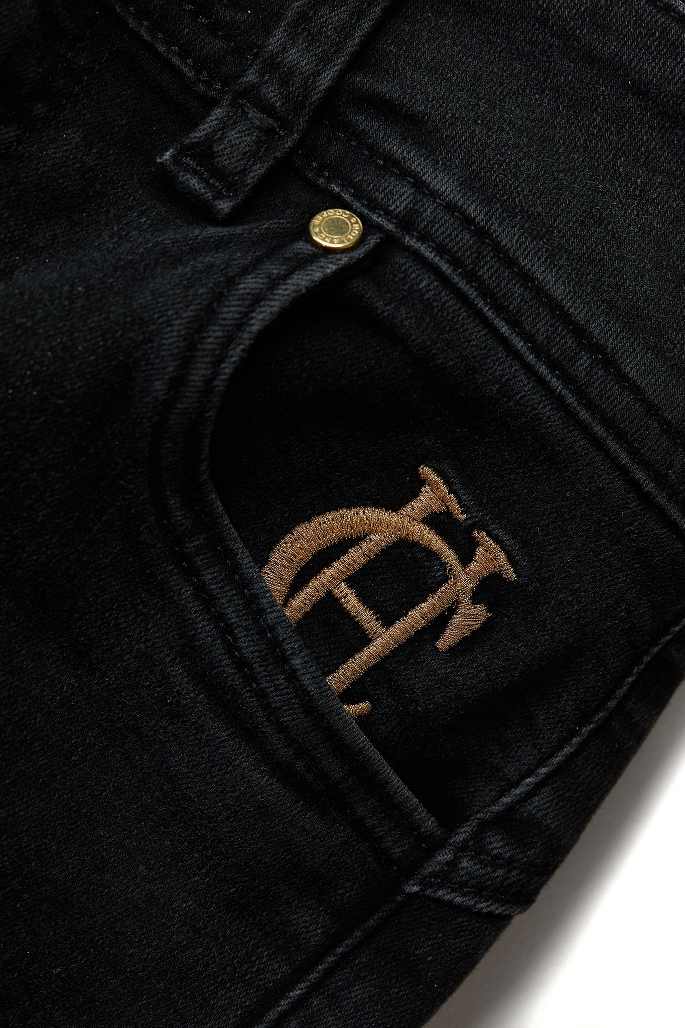hc embroidery detail on front left pocket on womens high rise washed black denim skinny stretch jean with jodhpur style seam and two open pockets to the front