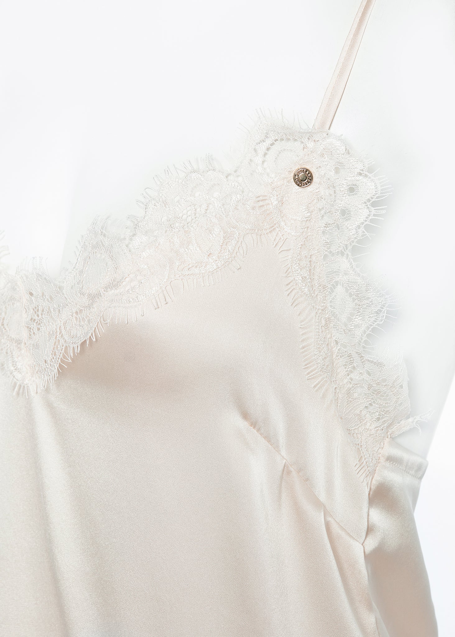 detail of lace v-neckline with delicate holland cooper hardware
