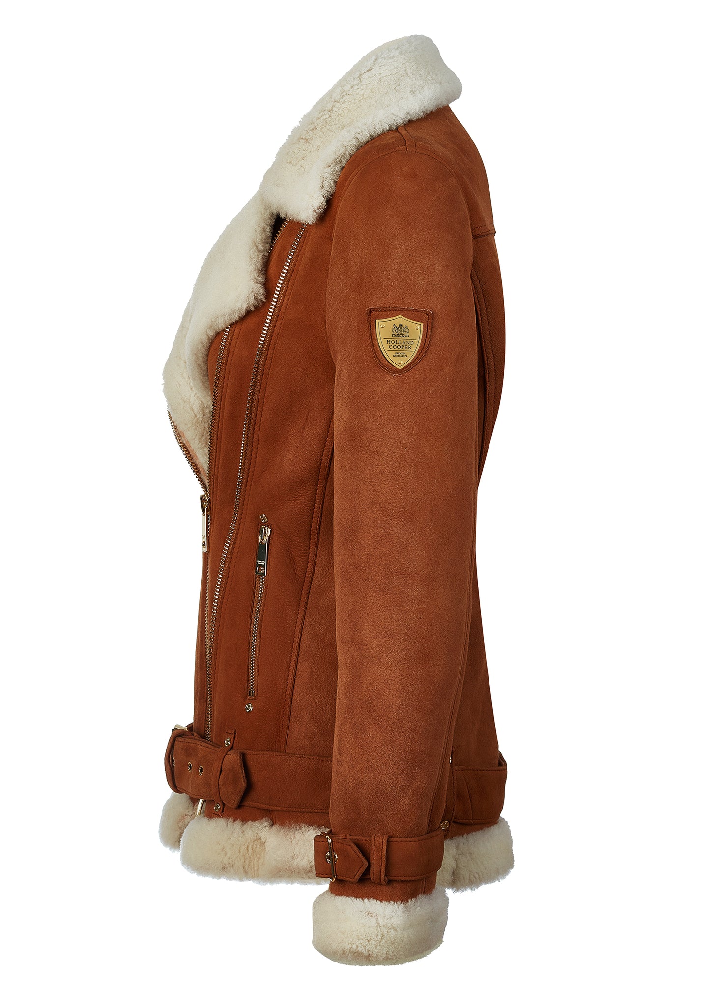 side of classic aviator jacket in tan leather with cream shearling inside that accents the cuffs hem and collar with belt detail on the hem and cuffs three pockets and angular zip fastening