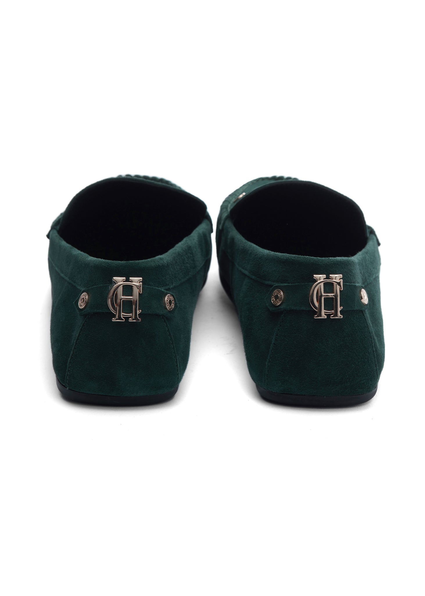 Back of classic emerald green suede loafers with a leather sole and gold hardware 