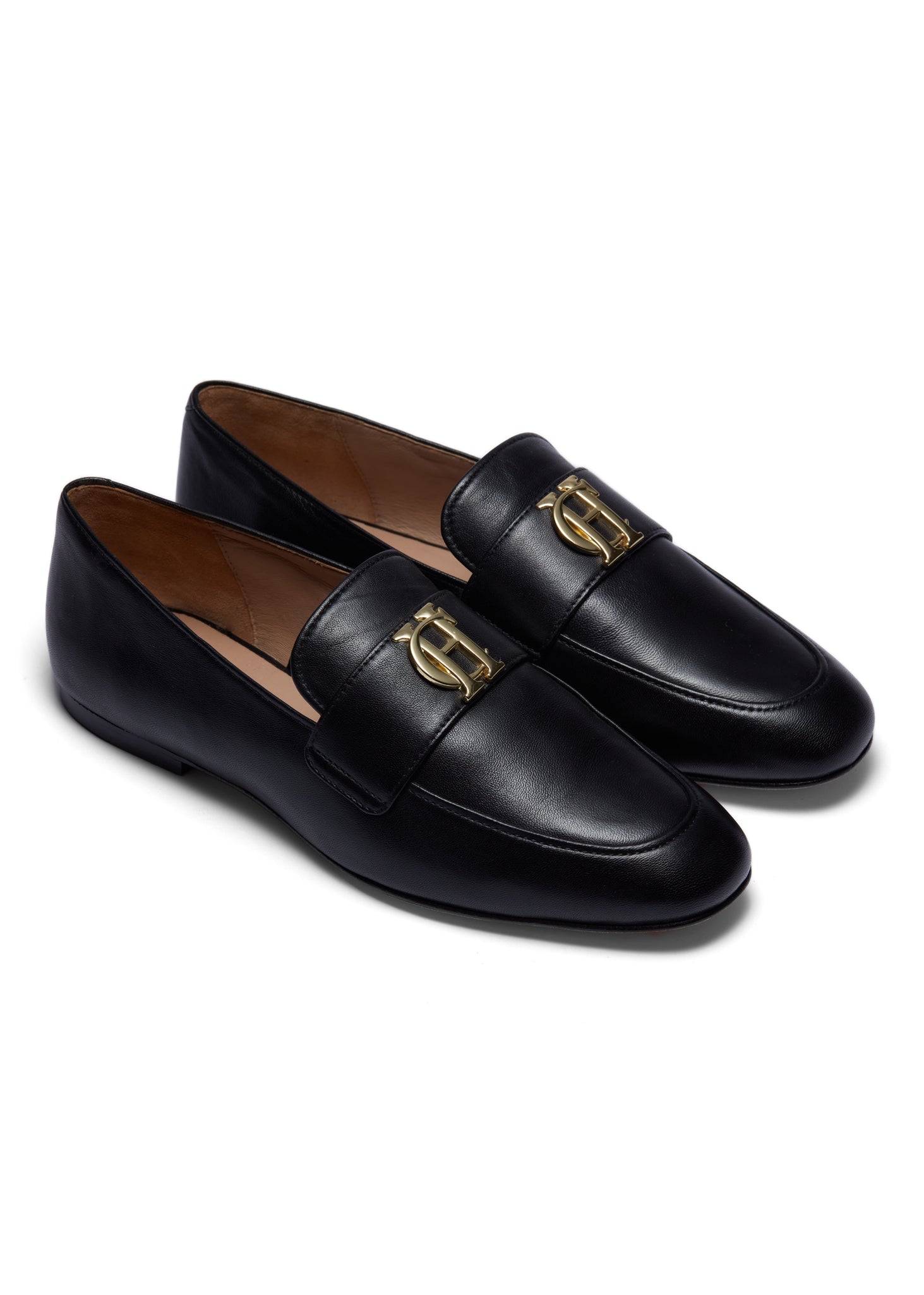 black leather loafers with a slightly pointed toe and gold hardware to the top
