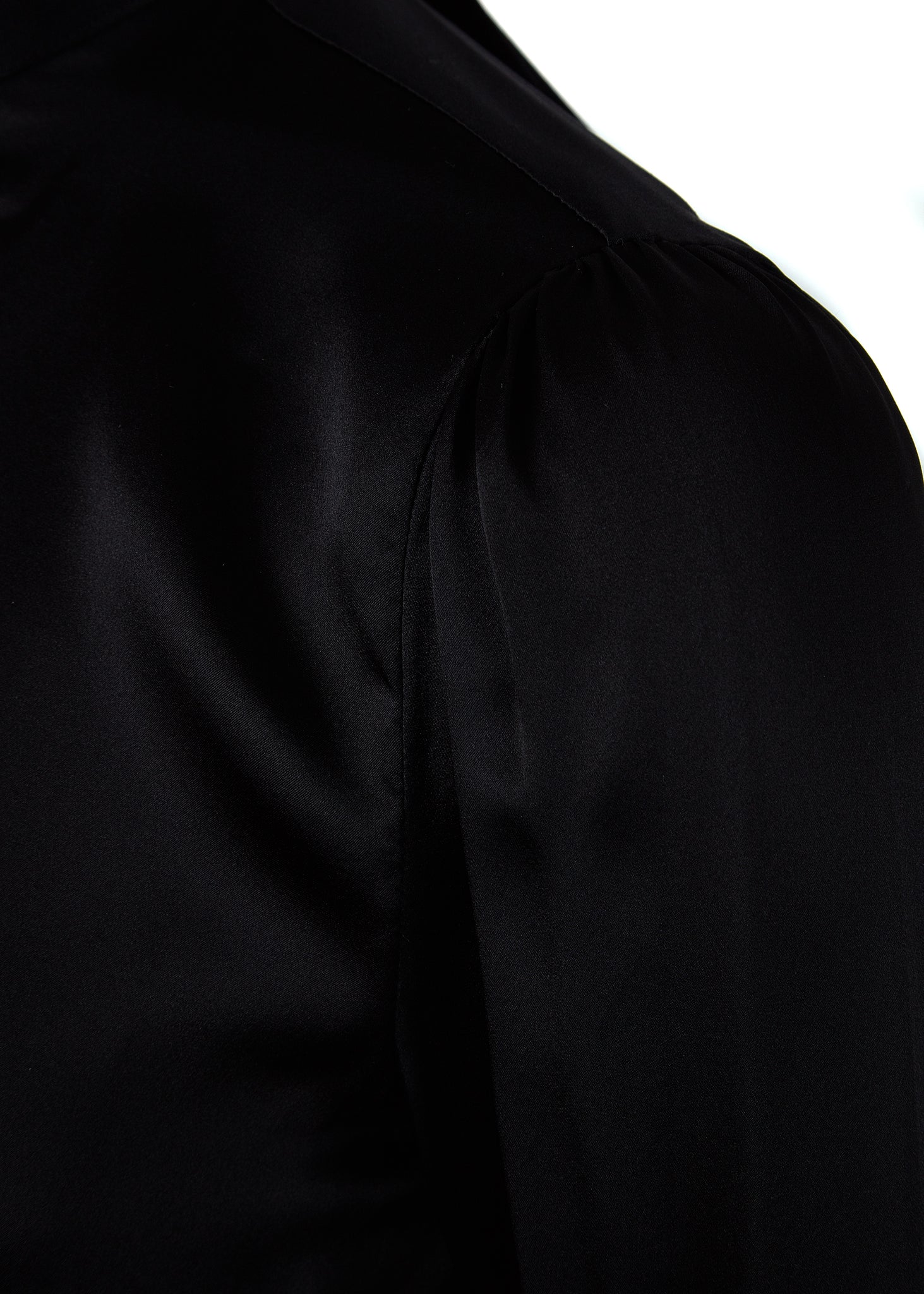 shoulder detail on womens black long sleeve silk blouse with neck tie and gold hardware