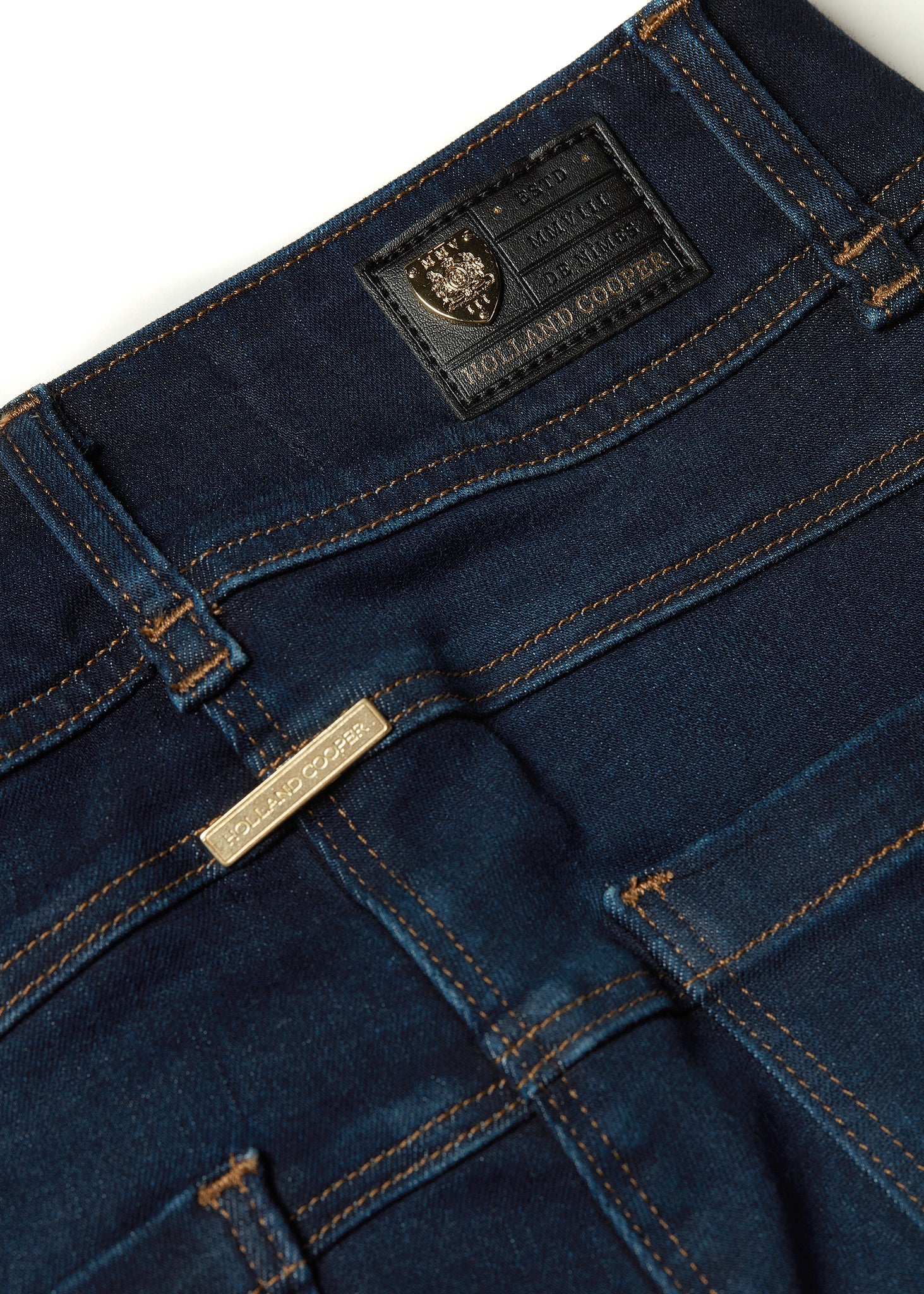 gold hardware detail on back of womens high rise dark blue denim skinny stretch thermal jean with jodhpur style seams and two open pockets to the front and back with internal fleece lining and hc gold crest on front right pocket