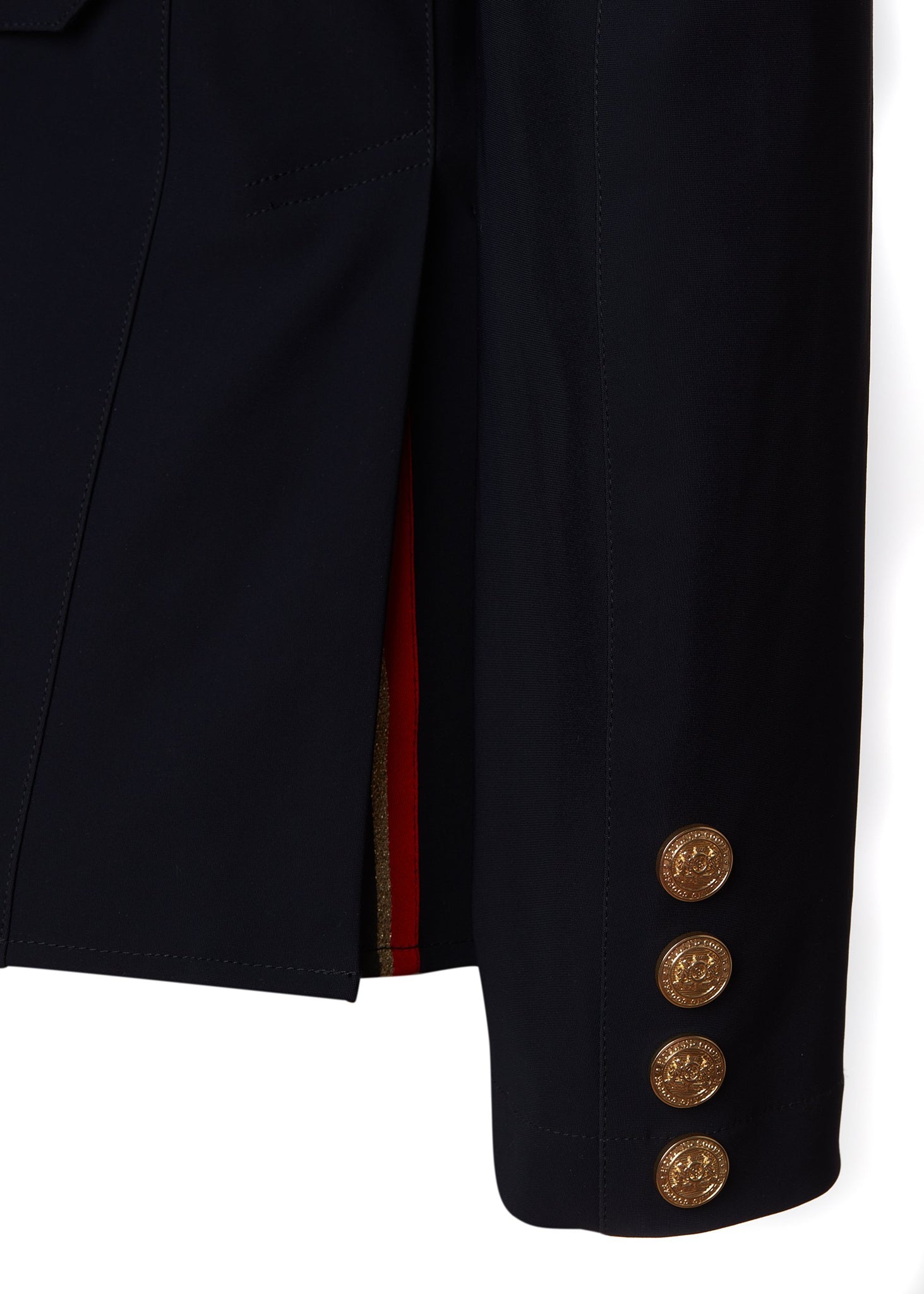 sleeve detail of womens navy competition jacket with gold hardware 