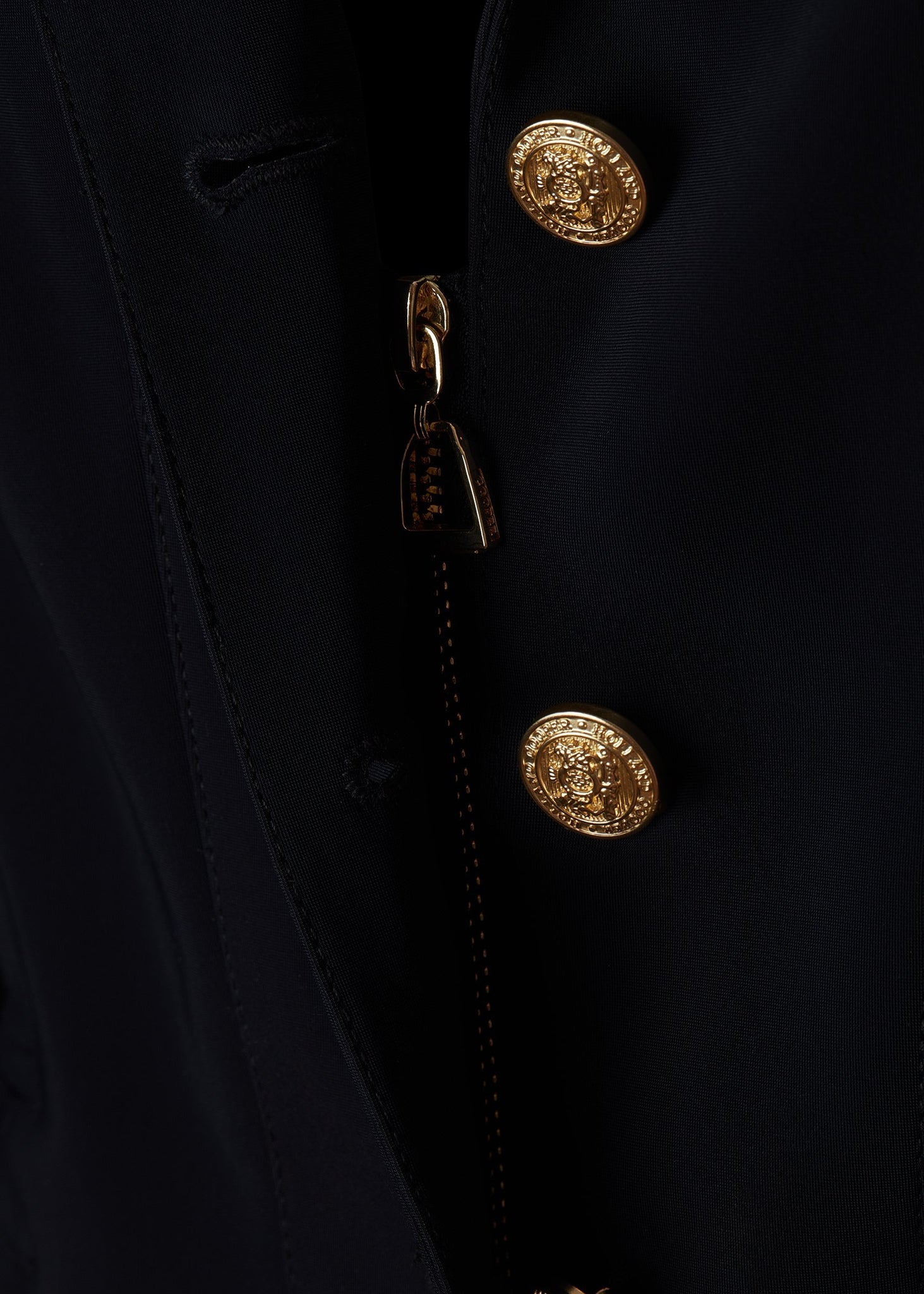 zip detail of womens navy competition jacket with gold hardware 