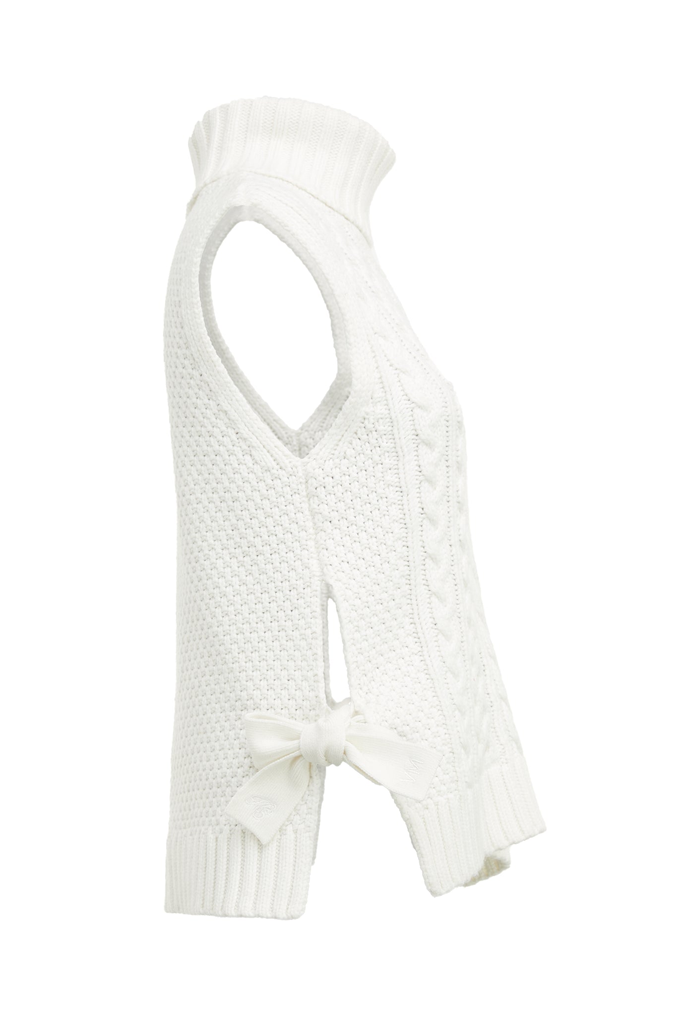 Side of sleeveless white chunky knit cable jumper with a roll neck and ties at each side 