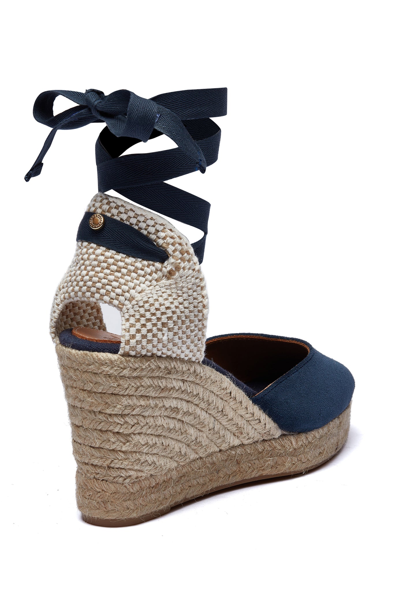 Back of 4 inch braided jute wedge heel with navy suede top and tie up navy ribbons around the ankle with gold hardware to the back.