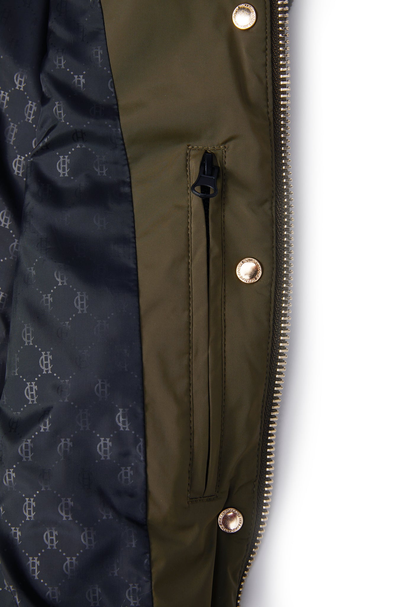 detail shot of the inner zip and monogram lining of the womens khaki quilted gilet with a dark brown collar and seams along the arm holes with drawstring toggles on the waist and two front pockets