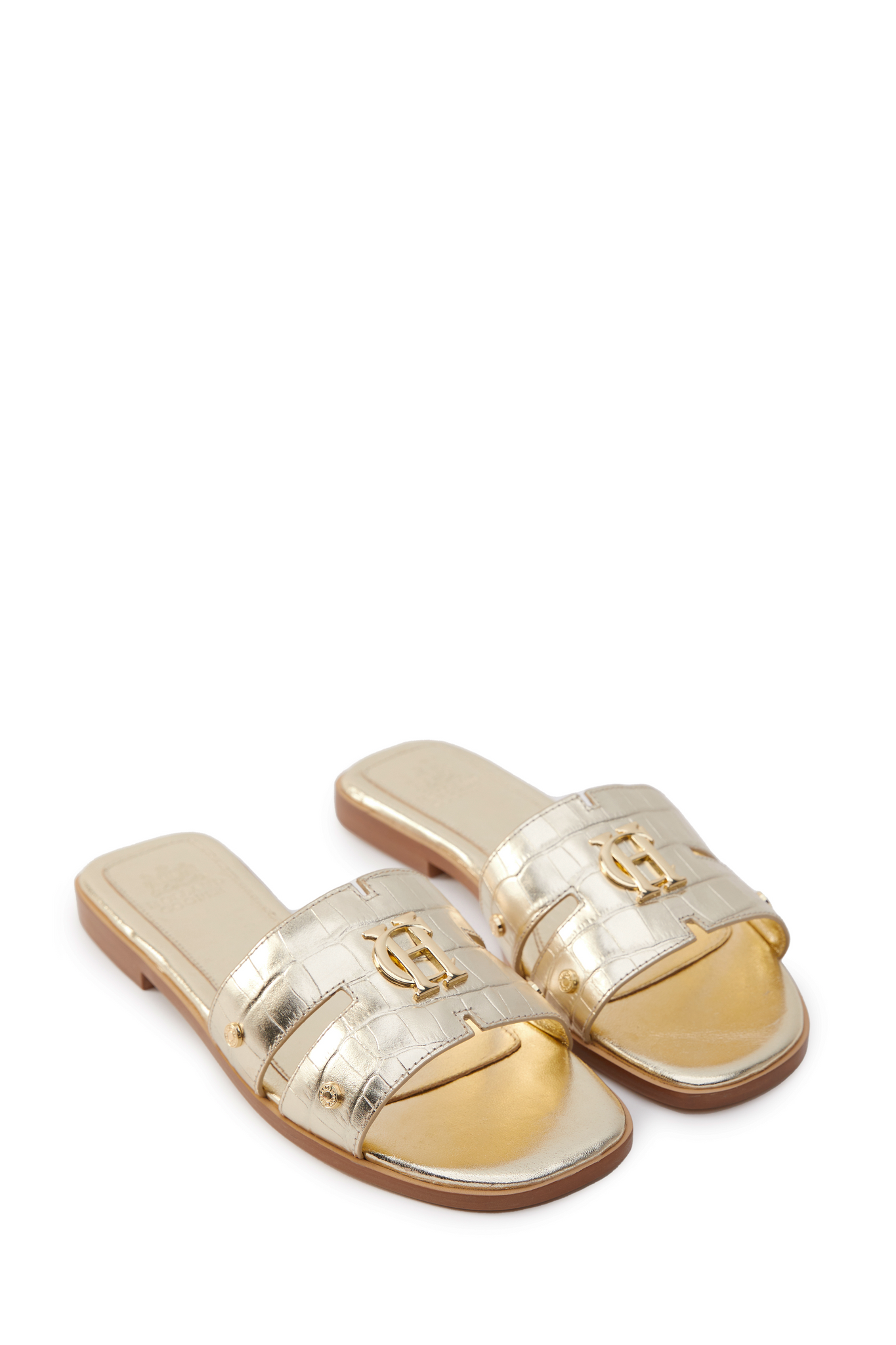 Gold croc embossed leather sliders with a tan leather sole and gold hardware. 