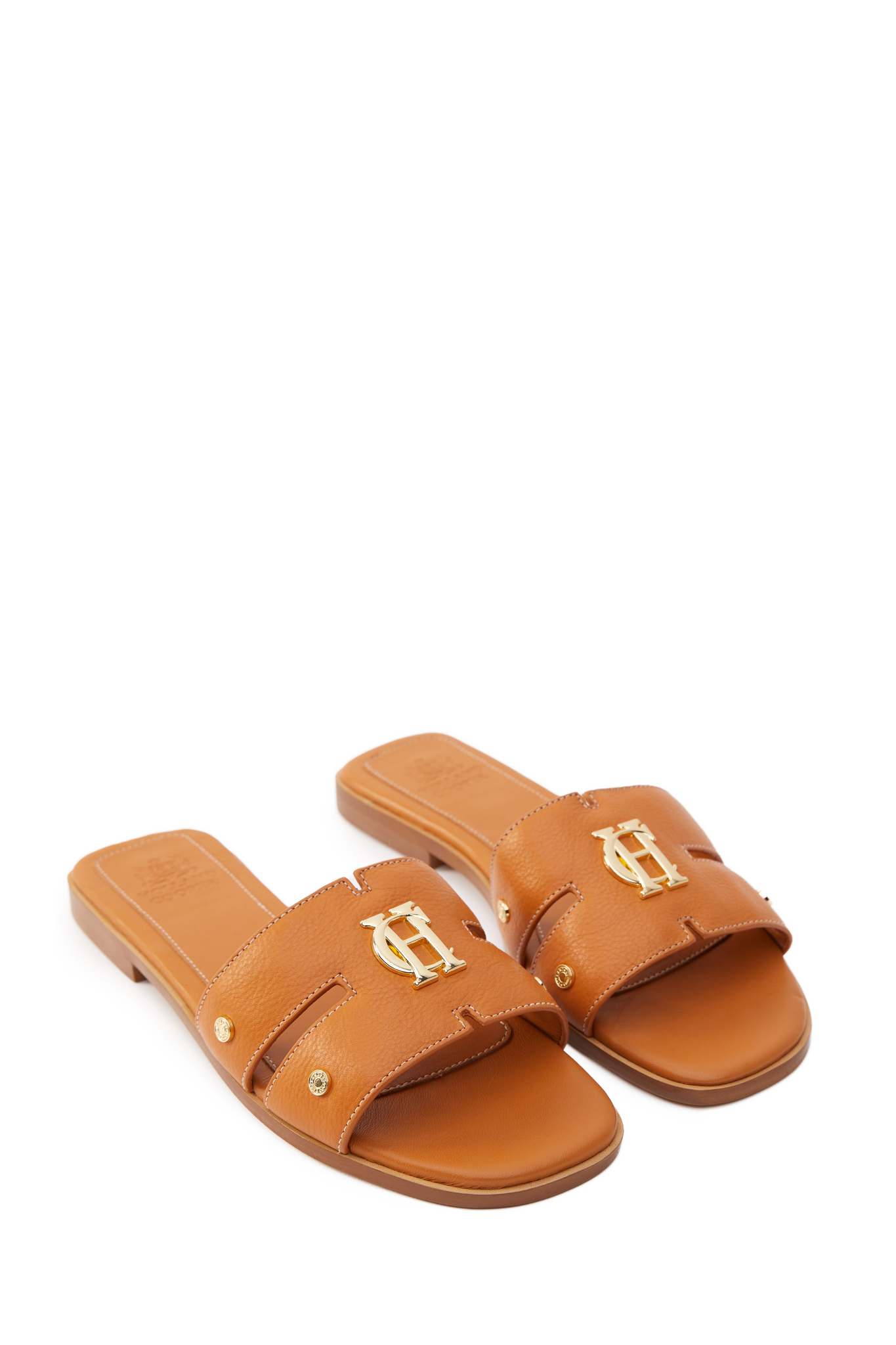 tan leather sliders with contrast white stitching, a tan leather sole and gold hardware