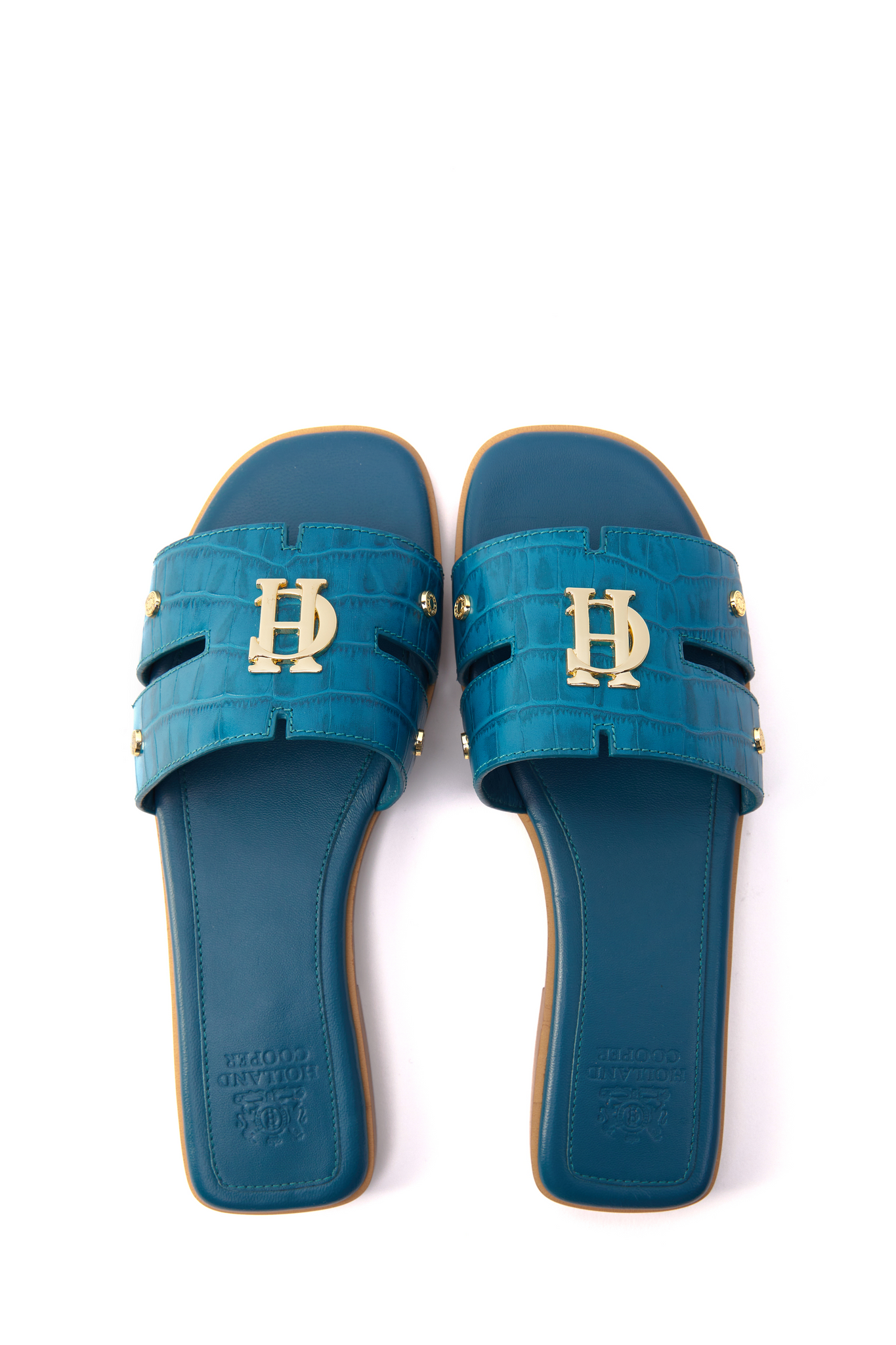 Birds eye view of Teal blue croc embossed leather sliders with  a tan leather sole and gold hardware.