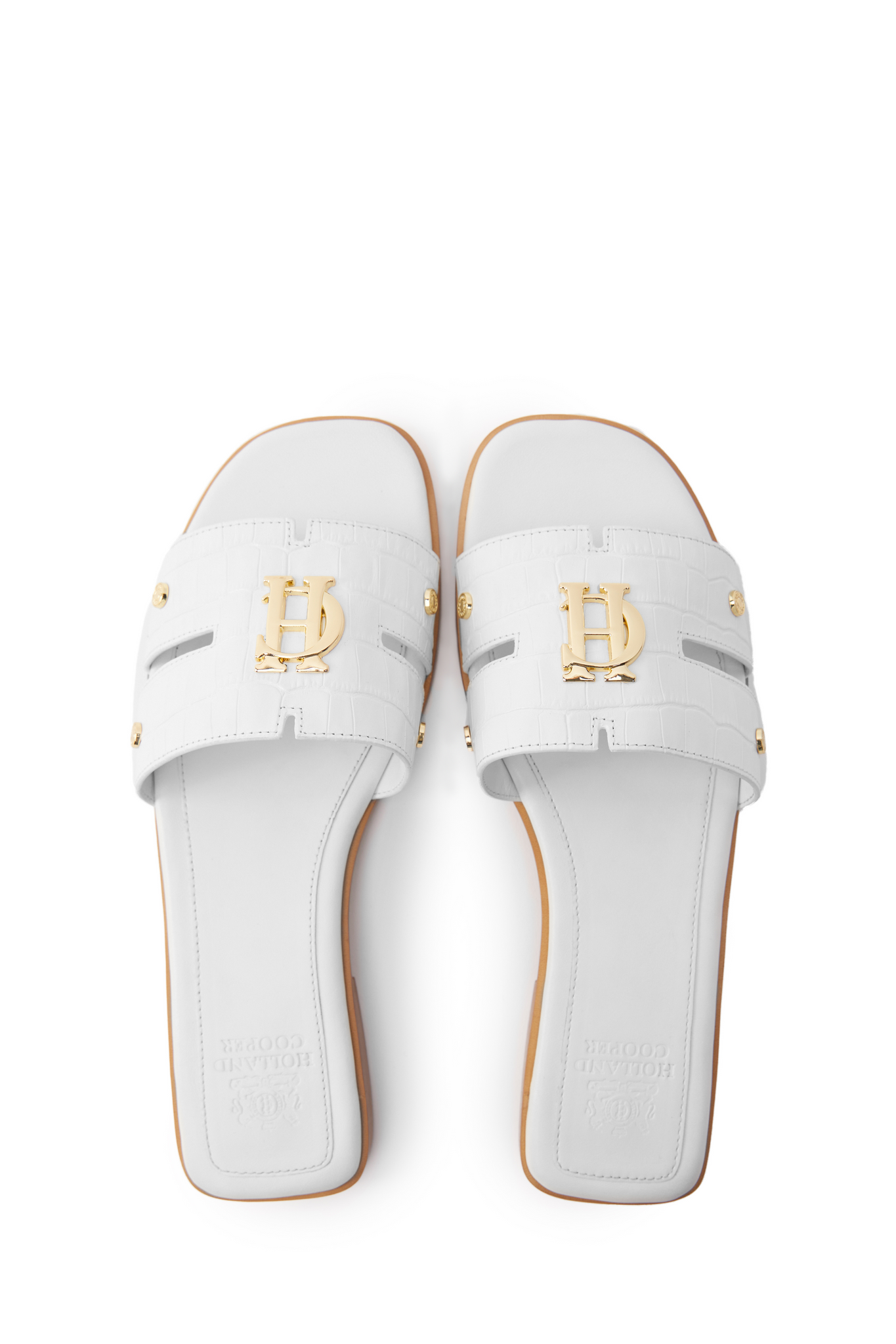 Birds eye view of white croc embossed leather sliders with a tan leather sole and gold hardware