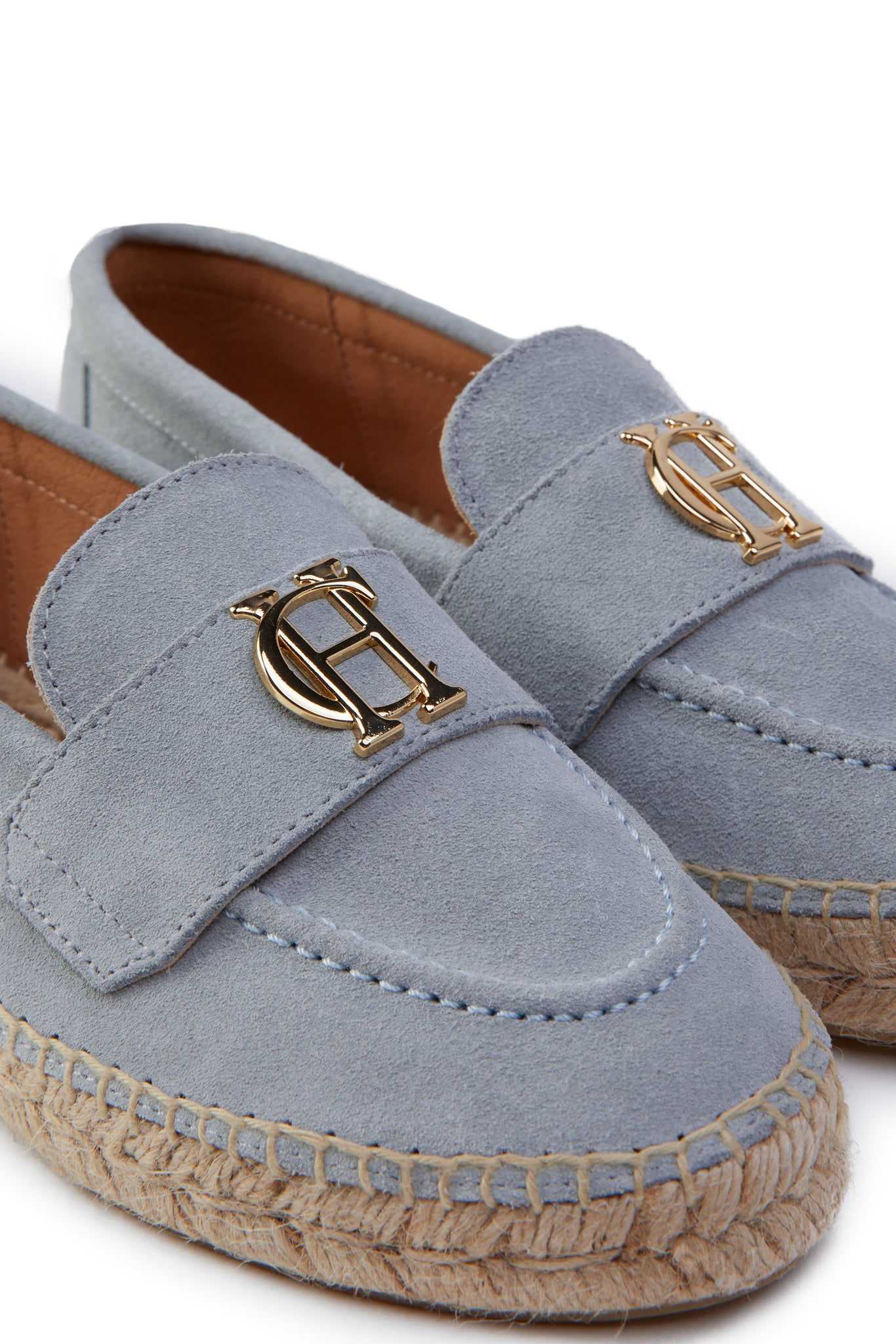 Close up of gold hardware on light blue suede classic espadrille with plaited jute sole